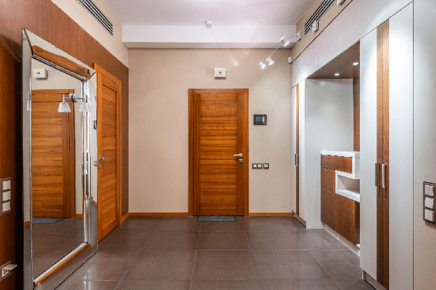 A finished hallway fitted with flush wood-veneer interior doors.